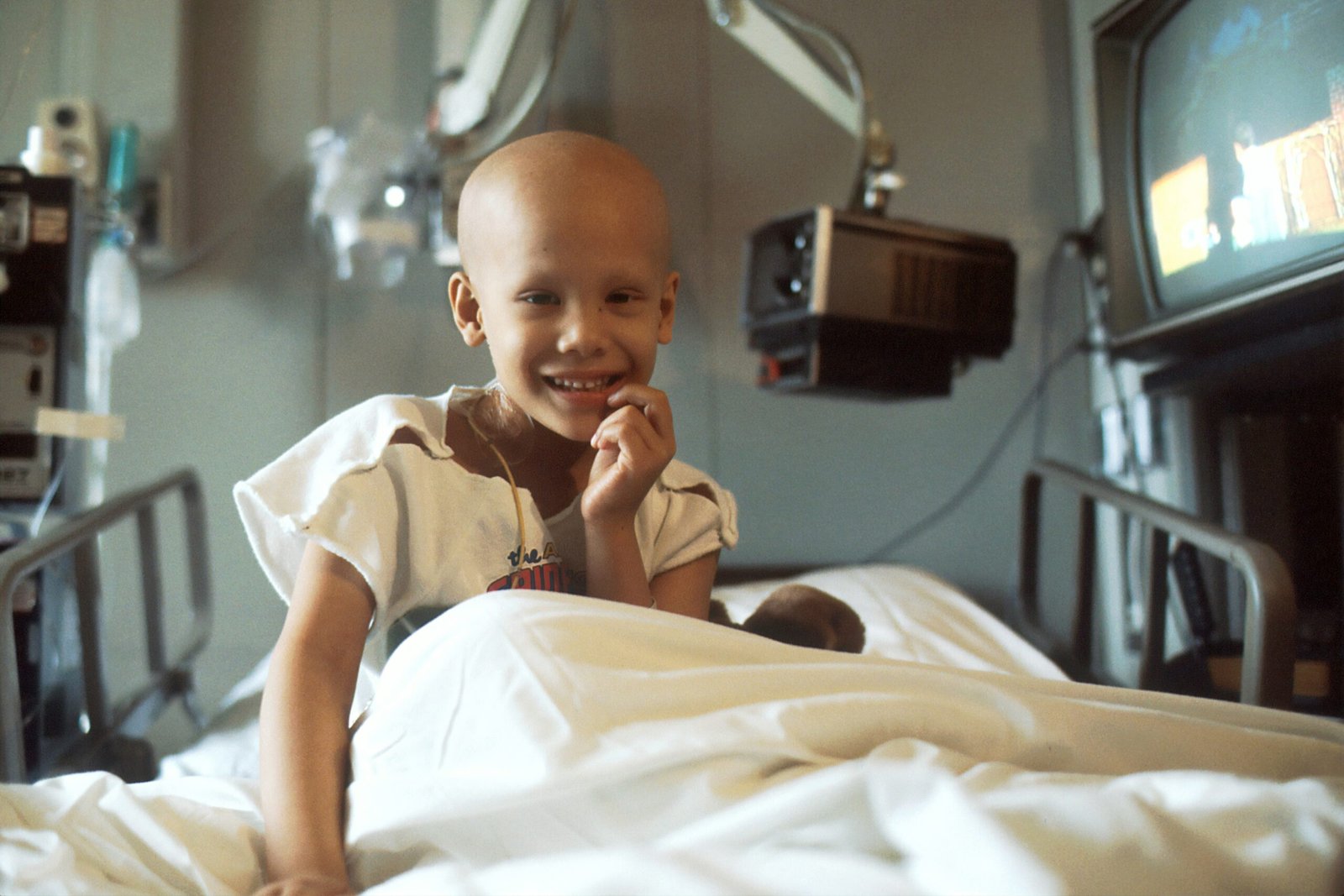 child sitting on bed